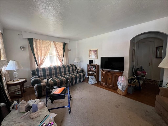 1104 Jefferson St, Mckeesport, PA 15132 - living area featuring wood finished floors, arched walkways, and a textured ceiling