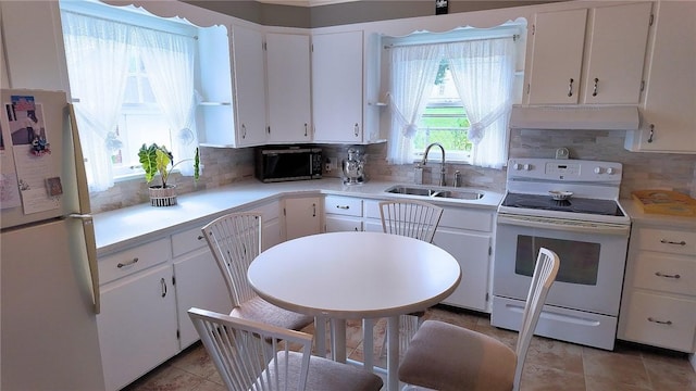 539 Milliken Ave, Sharpsville, PA 16150 - kitchen featuring white appliances, under cabinet range hood, light countertops, and white cabinetry