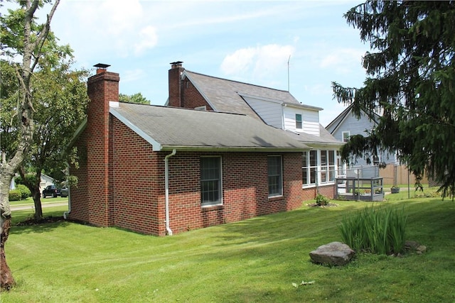 539 Milliken Ave, Sharpsville, PA 16150 - rear view of property featuring a lawn, brick siding, a shingled roof, and a chimney