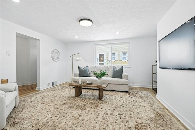 1233 High St, Spring Garden, PA 15212 - living area featuring wood finished floors, recessed lighting, and a textured ceiling