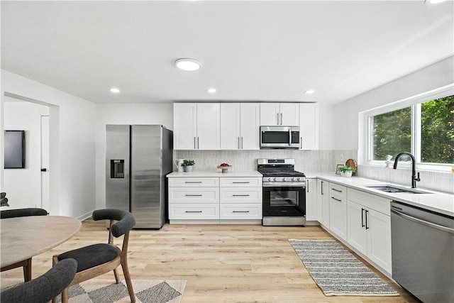 1233 High St, Spring Garden, PA 15212 - kitchen featuring appliances with stainless steel finishes, decorative backsplash, light countertops, white cabinetry, and recessed lighting