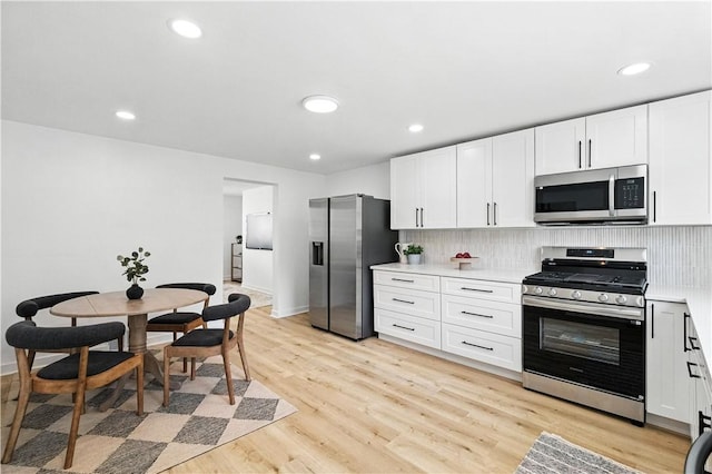 1233 High St, Spring Garden, PA 15212 - kitchen with stainless steel appliances, backsplash, white cabinetry, light countertops, and recessed lighting