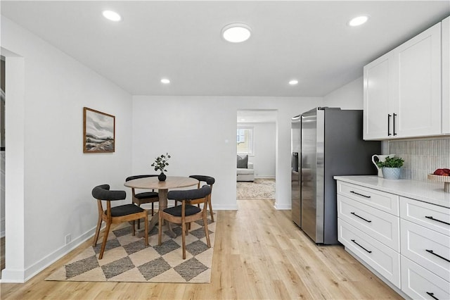 1233 High St, Spring Garden, PA 15212 - kitchen with light wood-style floors, white cabinetry, stainless steel refrigerator with ice dispenser, light countertops, and recessed lighting