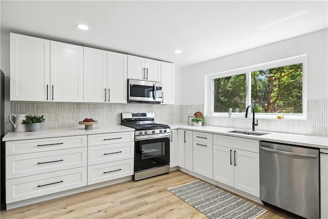 1233 High St, Spring Garden, PA 15212 - kitchen featuring appliances with stainless steel finishes, white cabinetry, light countertops, backsplash, and recessed lighting