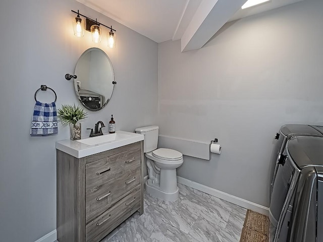 554 Rolling Green Dr, Bethel Park, PA 15102 - bathroom with washer and dryer, vanity, and marble finish flooring