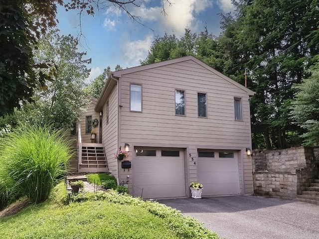 554 Rolling Green Dr, Bethel Park, PA 15102 - view of property exterior with a garage, stairway, and driveway