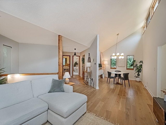 554 Rolling Green Dr, Bethel Park, PA 15102 - living area with light wood-type flooring, a chandelier, and high vaulted ceiling