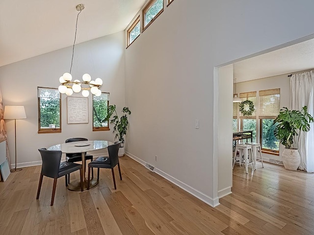 554 Rolling Green Dr, Bethel Park, PA 15102 - dining room featuring high vaulted ceiling, light wood-style floors, and a chandelier
