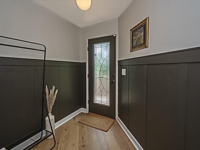 554 Rolling Green Dr, Bethel Park, PA 15102 - entrance foyer with light wood-style floors, wainscoting, and a decorative wall