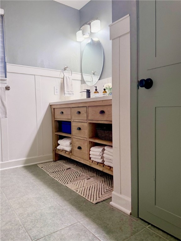 554 Rolling Green Dr, Bethel Park, PA 15102 - bathroom with vanity, a decorative wall, a wainscoted wall, and tile patterned floors