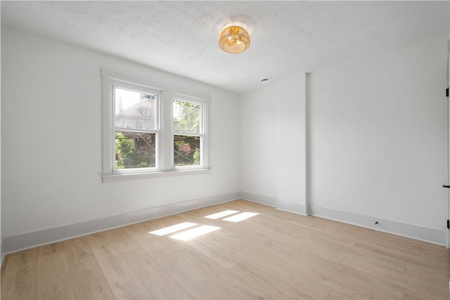 3246 Piedmont Ave, Dormont, PA 15216 - empty room with a textured ceiling and light wood-style floors