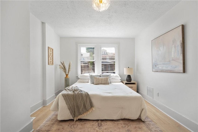 3246 Piedmont Ave, Dormont, PA 15216 - bedroom with light wood-style flooring and a textured ceiling