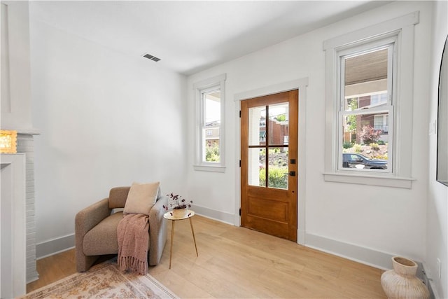 3246 Piedmont Ave, Dormont, PA 15216 - sitting room with light wood-type flooring and a brick fireplace