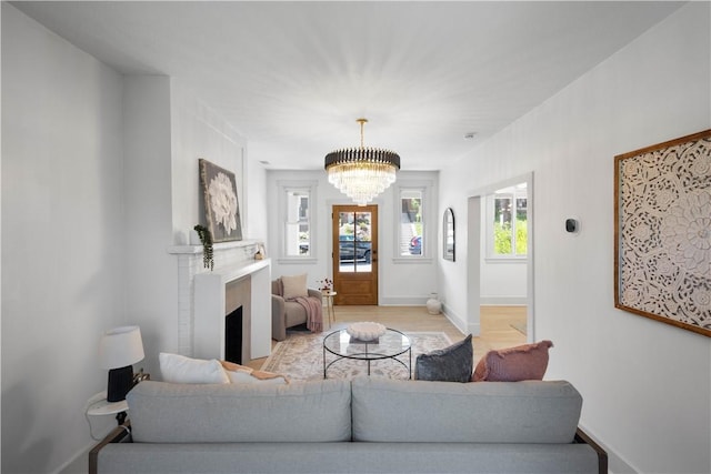 3246 Piedmont Ave, Dormont, PA 15216 - living room with a chandelier, a fireplace, and light wood finished floors