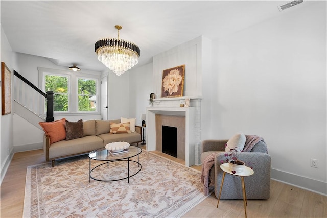 3246 Piedmont Ave, Dormont, PA 15216 - living room featuring wood finished floors, a chandelier, and a fireplace with flush hearth