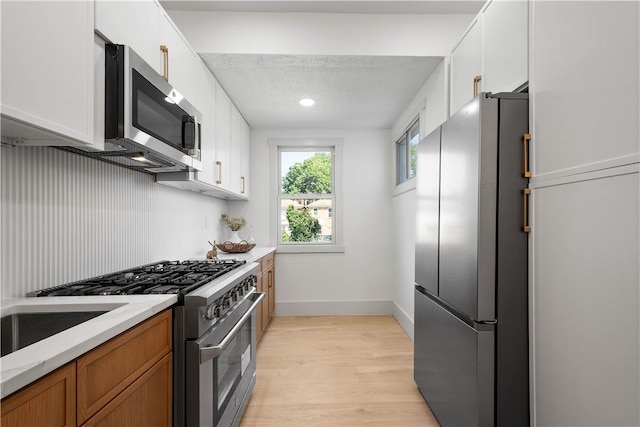 3246 Piedmont Ave, Dormont, PA 15216 - kitchen featuring stainless steel appliances, light wood-style flooring, white cabinetry, light stone counters, and brown cabinetry