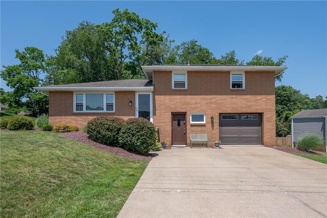 205 Eleanor Dr, Latrobe, PA 15650 - split level home with an attached garage, driveway, brick siding, and a front yard