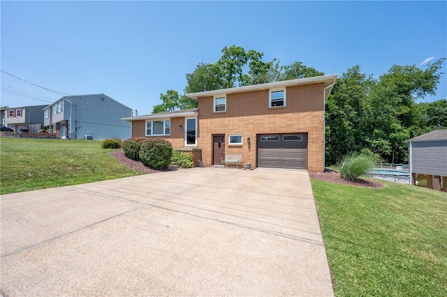 205 Eleanor Dr, Latrobe, PA 15650 - split level home with driveway, an attached garage, brick siding, and a front lawn