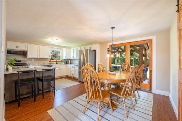 205 Eleanor Dr, Latrobe, PA 15650 - dining area featuring wood finished floors and a chandelier