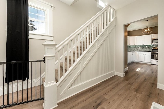 413 Spring St, Grove City Boro, PA 16127 - stairs featuring wood finished floors and a chandelier