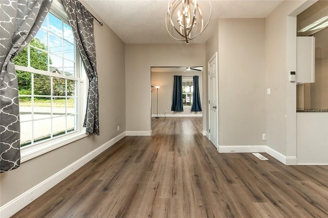 413 Spring St, Grove City Boro, PA 16127 - hallway featuring wood finished floors, a chandelier, and plenty of natural light