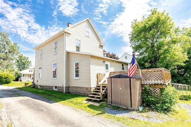 413 Spring St, Grove City Boro, PA 16127 - view of home's exterior with a shed, a chimney, and a deck