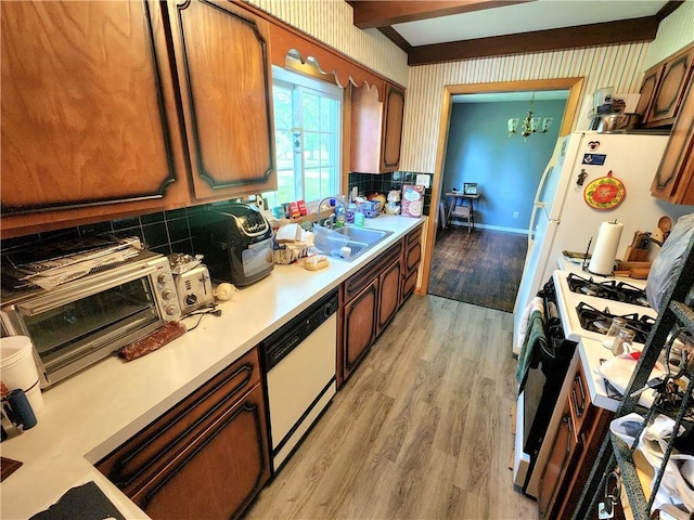 1426 S Darby Rd, Hermitage, PA 16148 - kitchen featuring white dishwasher, gas range, light wood-type flooring, light countertops, and a chandelier