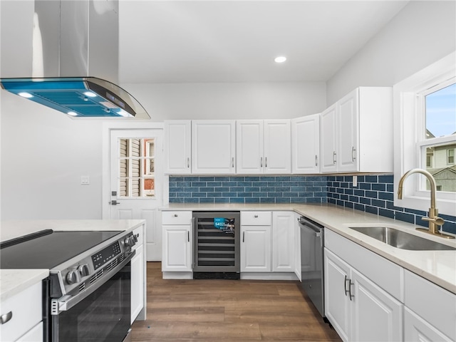 710 7th Ave, New Brighton, PA 15066 - kitchen featuring stainless steel appliances, island range hood, wine cooler, backsplash, and white cabinetry
