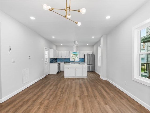 710 7th Ave, New Brighton, PA 15066 - kitchen featuring freestanding refrigerator, white cabinets, dark wood-type flooring, a chandelier, and light countertops