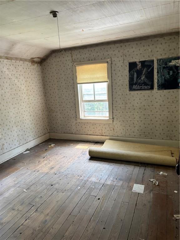 65 Old Mine Rd, Center Twp/Homer Cty, PA 15748 - empty room with hardwood / wood-style flooring, wallpapered walls, and vaulted ceiling