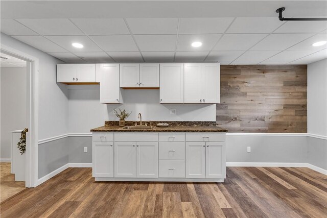 2161/2 Robin Hood Dr, Irwin, PA 15642 - kitchen with wood finished floors, a paneled ceiling, white cabinetry, wood walls, and recessed lighting