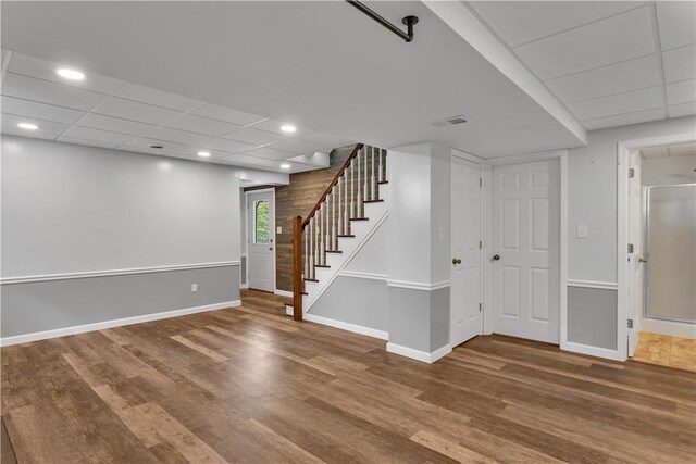 2161/2 Robin Hood Dr, Irwin, PA 15642 - below grade area with wood finished floors, stairway, a drop ceiling, and recessed lighting