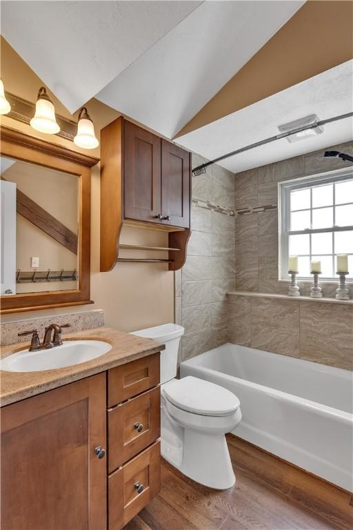 2161/2 Robin Hood Dr, Irwin, PA 15642 - full bathroom featuring vanity, lofted ceiling, washtub / shower combination, and wood finished floors