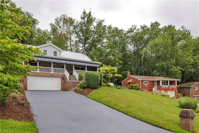 2161/2 Robin Hood Dr, Irwin, PA 15642 - view of front of property featuring asphalt driveway, an attached garage, stairs, a front lawn, and a chimney