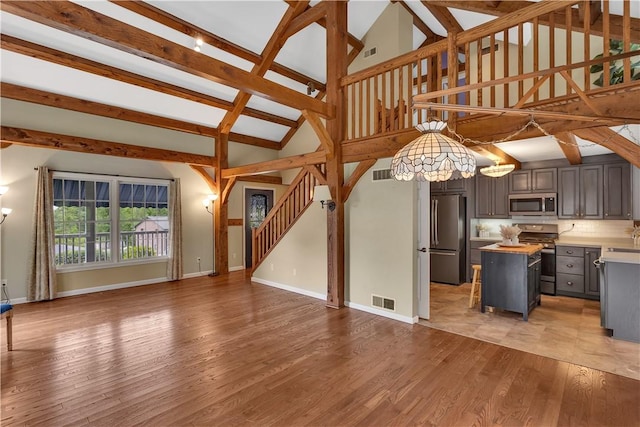 2161/2 Robin Hood Dr, Irwin, PA 15642 - kitchen featuring appliances with stainless steel finishes, open floor plan, a center island, a chandelier, and gray cabinetry