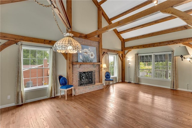 2161/2 Robin Hood Dr, Irwin, PA 15642 - unfurnished living room featuring a brick fireplace, healthy amount of natural light, and hardwood / wood-style floors