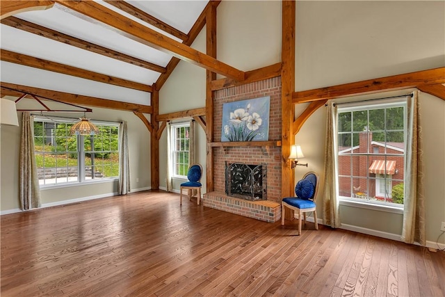2161/2 Robin Hood Dr, Irwin, PA 15642 - unfurnished living room with beam ceiling, wood-type flooring, a fireplace, plenty of natural light, and high vaulted ceiling
