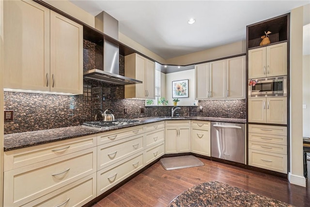 6092 Triple Crown Cir, Hempfield Twp, PA 15601 - kitchen with stainless steel appliances, wall chimney range hood, dark wood finished floors, backsplash, and dark stone counters