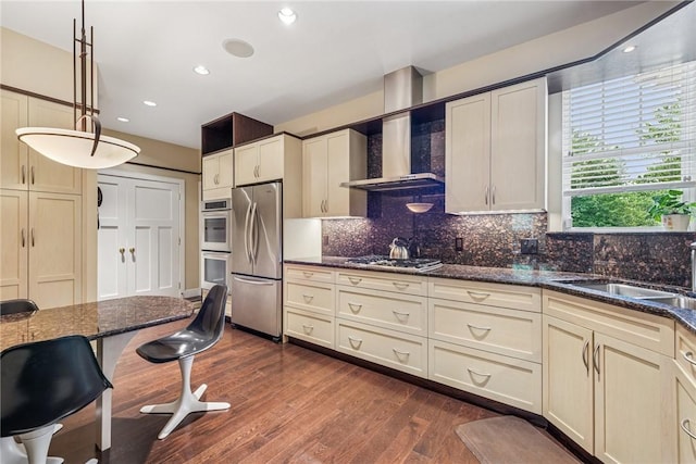 6092 Triple Crown Cir, Hempfield Twp, PA 15601 - kitchen featuring wall chimney exhaust hood, stainless steel appliances, backsplash, dark wood-style floors, and dark stone counters