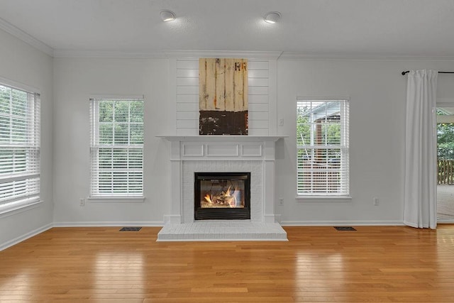 642 Water View Dr, Cranberry Twp, PA 16066 - unfurnished living room featuring ornamental molding, a brick fireplace, and hardwood / wood-style flooring