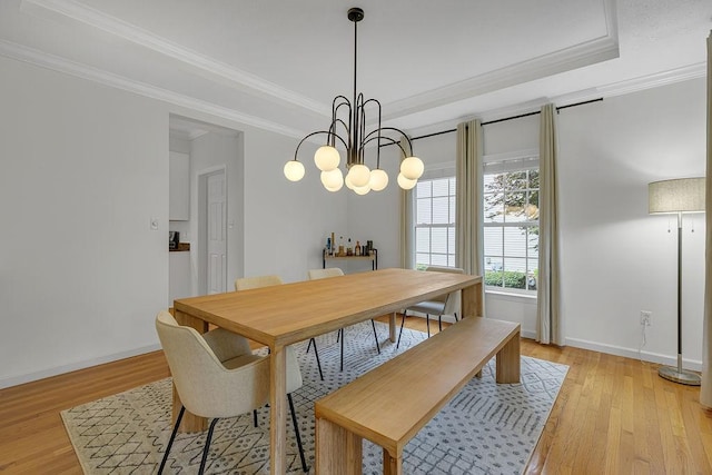 642 Water View Dr, Cranberry Twp, PA 16066 - dining area with light wood-style flooring, ornamental molding, a chandelier, and a tray ceiling