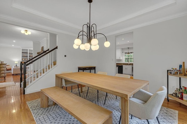 642 Water View Dr, Cranberry Twp, PA 16066 - dining space with light wood-type flooring, stairs, a tray ceiling, crown molding, and a chandelier
