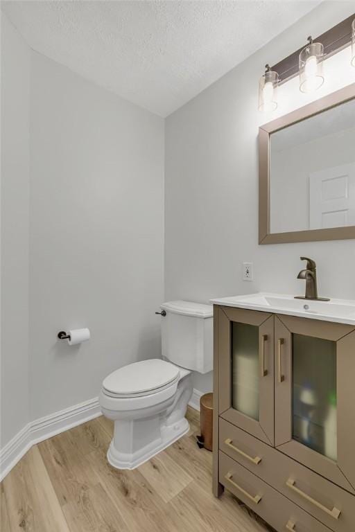 642 Water View Dr, Cranberry Twp, PA 16066 - half bath featuring wood finished floors, vanity, and a textured ceiling