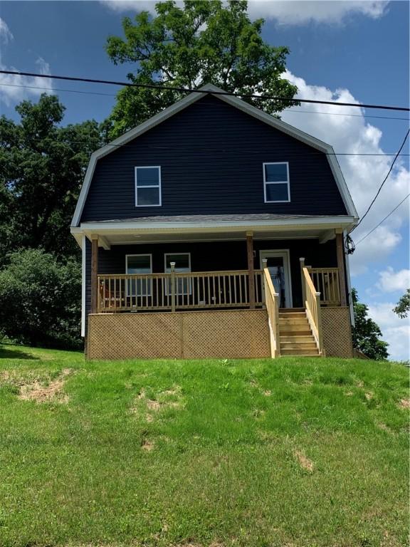 226 Main Street Ext, Callery Boro, PA 16024 - colonial inspired home featuring a porch, a gambrel roof, and a front lawn