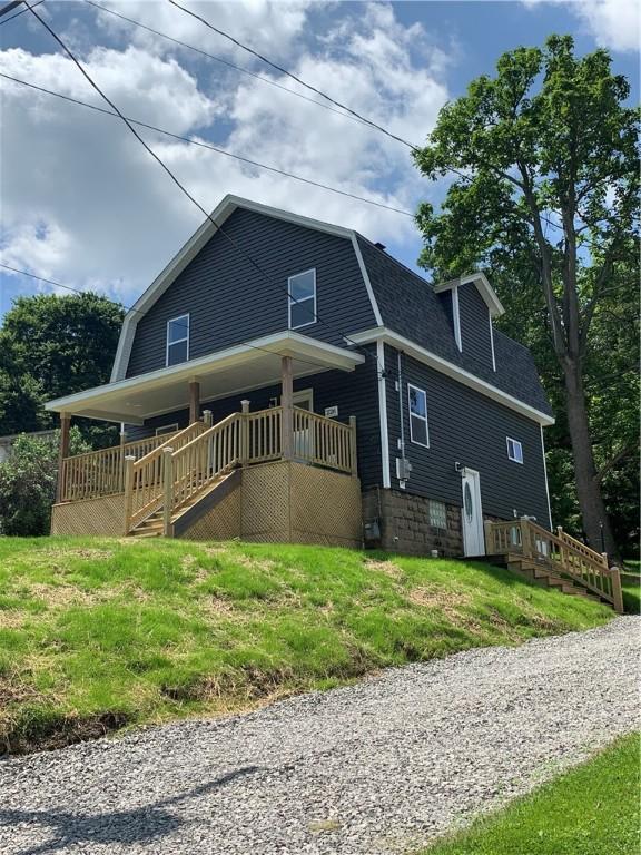 226 Main Street Ext, Callery Boro, PA 16024 - view of side of property with a gambrel roof, a shingled roof, a lawn, and stairway