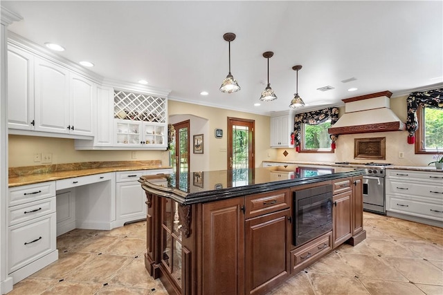 2590 Wildwood Rd, Hampton, PA 15101 - kitchen with black microwave, premium range hood, high end stainless steel range, white cabinetry, and ornamental molding