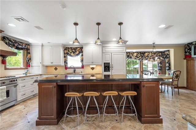 2590 Wildwood Rd, Hampton, PA 15101 - kitchen featuring high end appliances, white cabinets, a kitchen breakfast bar, recessed lighting, and pendant lighting