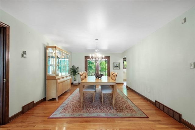 2590 Wildwood Rd, Hampton, PA 15101 - dining room with a chandelier and light wood-style flooring