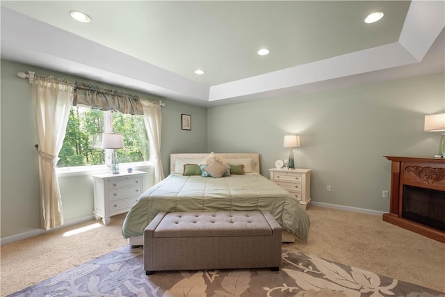 2590 Wildwood Rd, Hampton, PA 15101 - bedroom with light carpet, recessed lighting, a glass covered fireplace, and a tray ceiling
