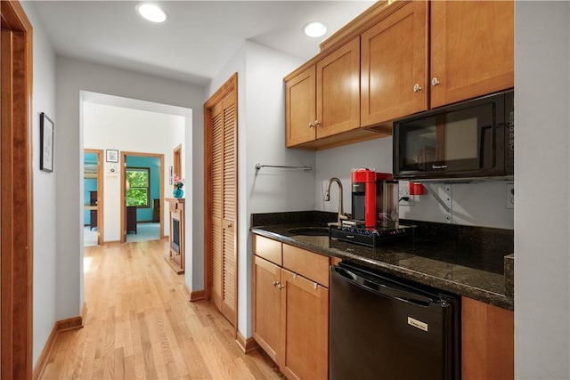 2590 Wildwood Rd, Hampton, PA 15101 - kitchen featuring black appliances, light wood-type flooring, recessed lighting, dark stone countertops, and brown cabinetry